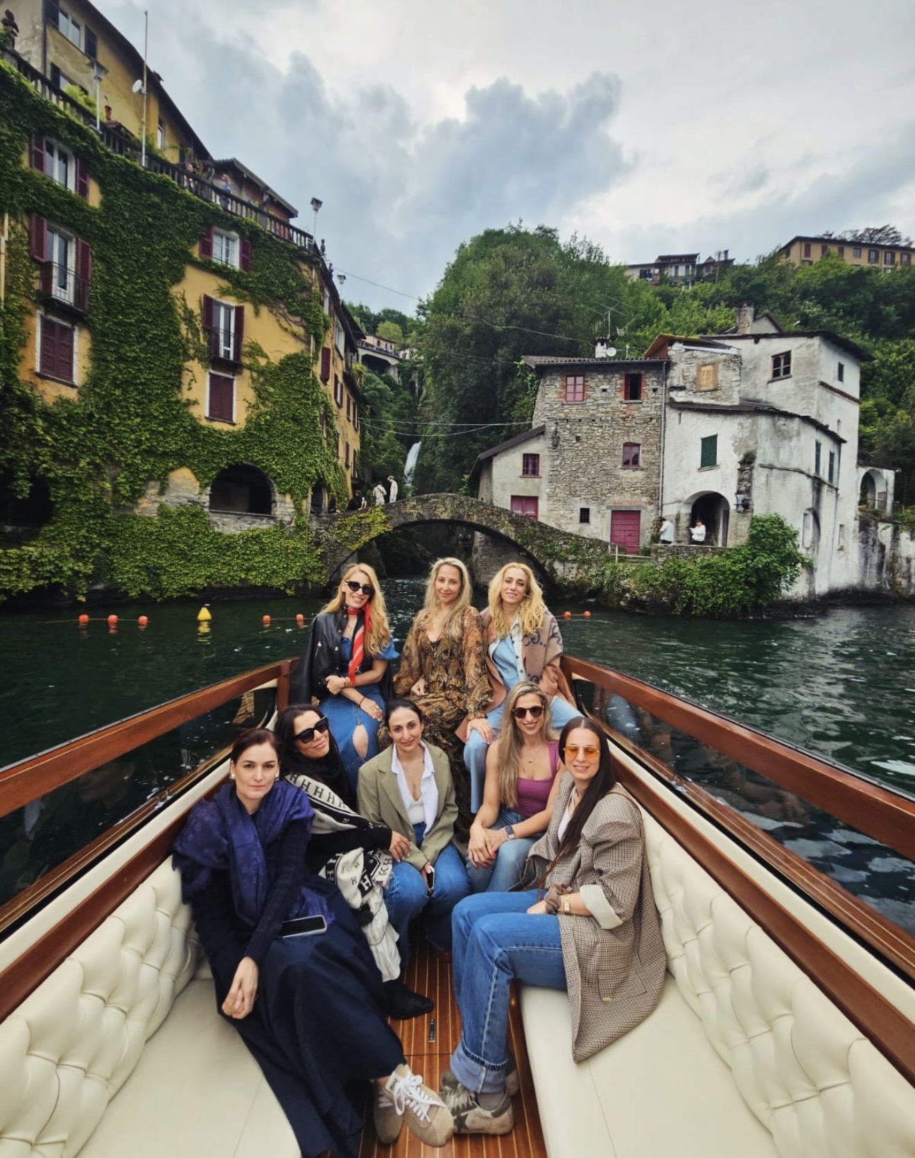 Guests on a classic wooden boat at Lake Como
